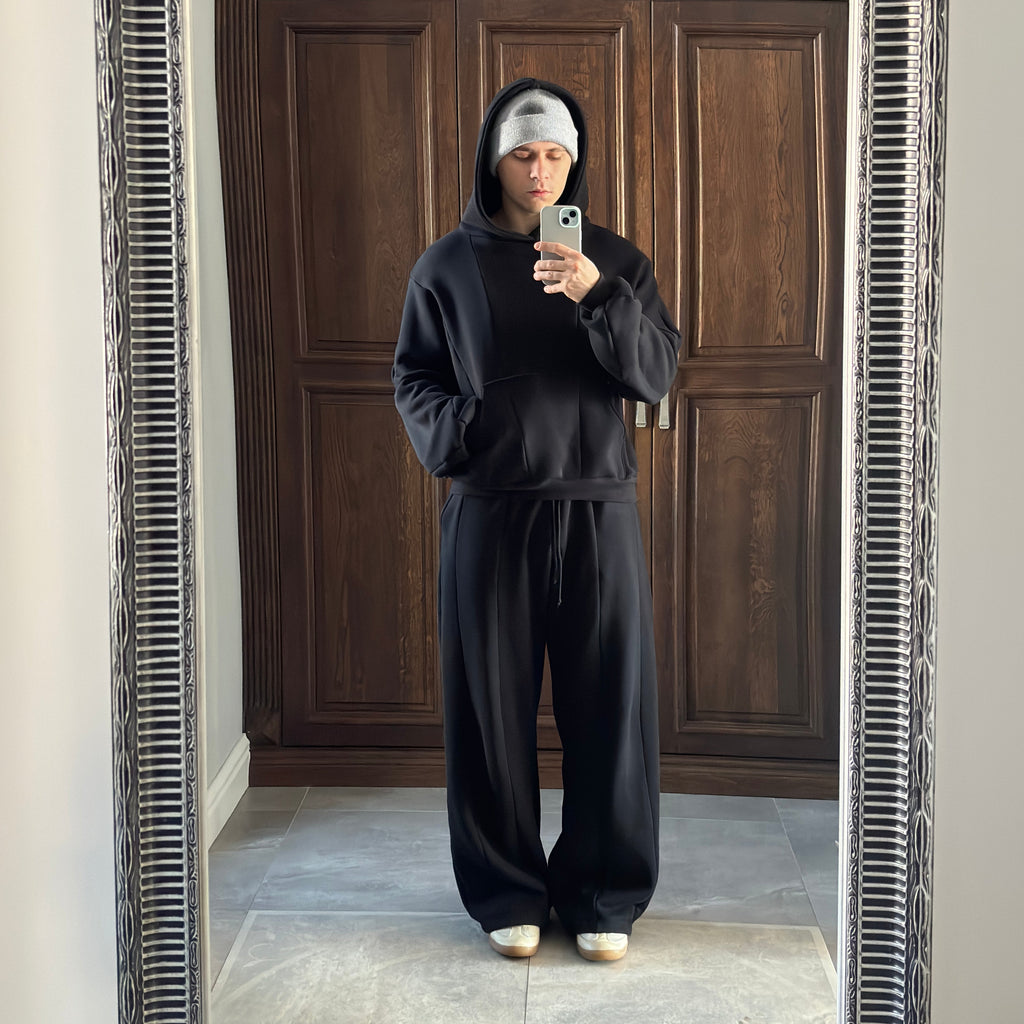 Person taking a mirror selfie in front of a wooden door